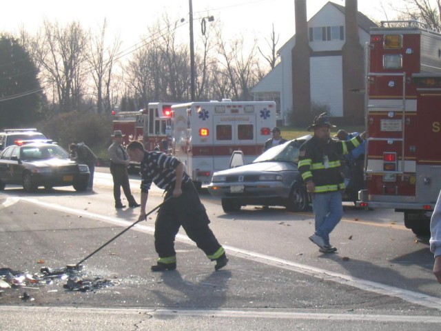 Firefighters clean up debris from roadway